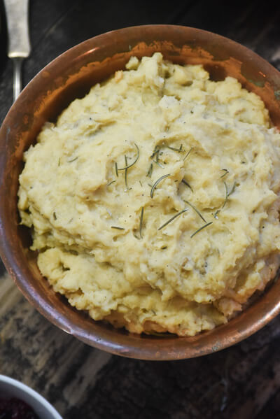 These slow cooker mashed potatoes are made with whole heads of roasted garlic and fresh rosemary. 