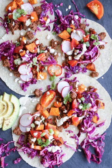 Spiced ground beef tacos with roasted sweet potatoes and dairy free queso