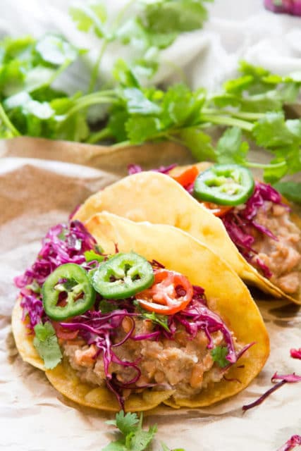 Drunken refried bean tacos with cilantro lime slaw 