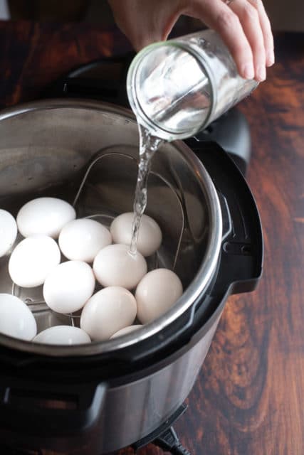 pouring water over eggs in the instant pot