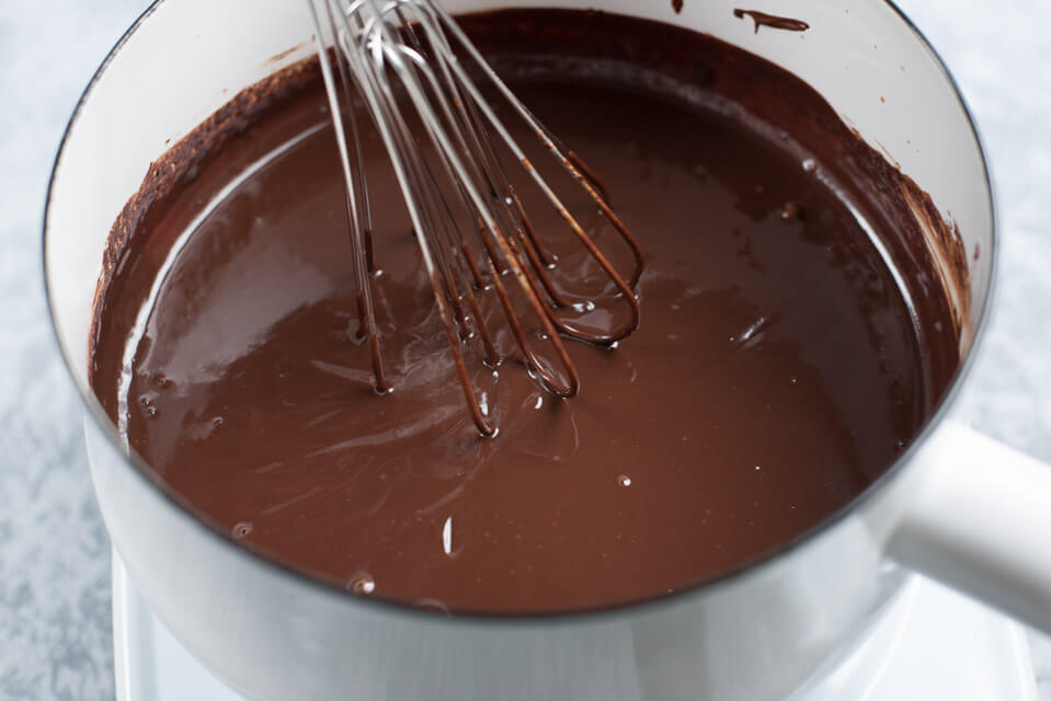 whisking chocolate for pretzels