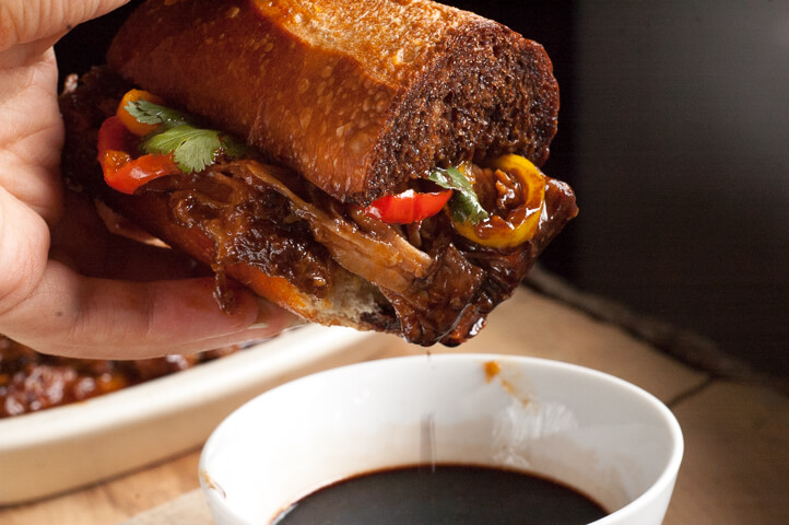 Barbecue Balsamic Pulled Pork Sandwiches. Simmered all day in sweet and spicy barbecue sauce, piled on a butter crisped bun with caramelized sweet peppers and served with tangy balsamic vinegar.
