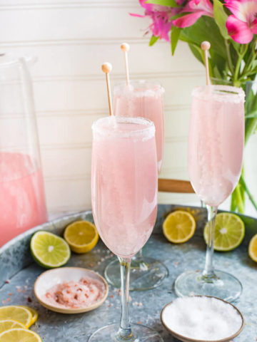 picture of 3 pink alcoholic drink in a champagne flute